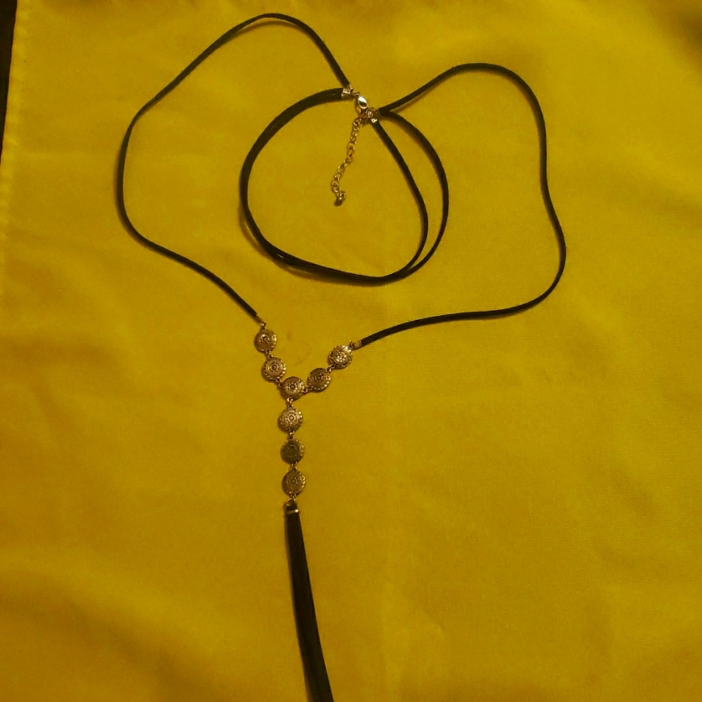 Black cord and silver colored necklace